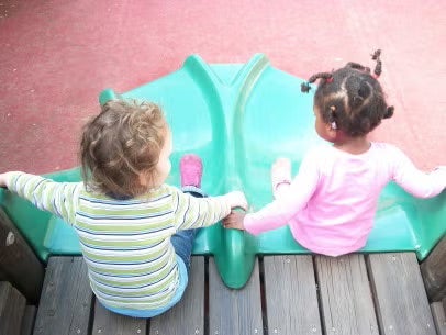 children going down a slide together