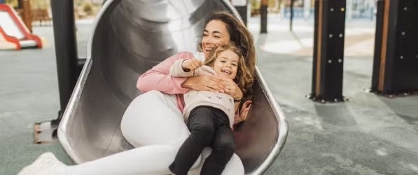 Parent and child on a slide