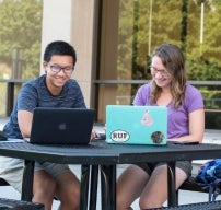 students working at computers outside