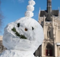 a smiling snowman face with heinz chapel in the background