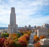 view of the cathedral of learning and fifth avenue during fall
